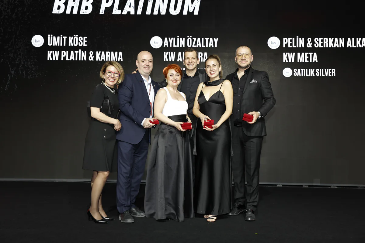 Pelin ve Serkan Alkan, ödül alan diğer danışmanlarla birlikte sahnede; arkadaki ekranda adları yazıyor